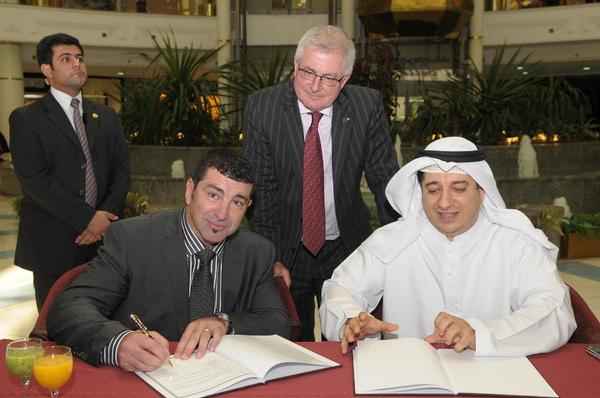 David Reid signing a Middle East deal, witnessed by Trade Minister Tim Groser, before the September 4 earthquake in Christchurch